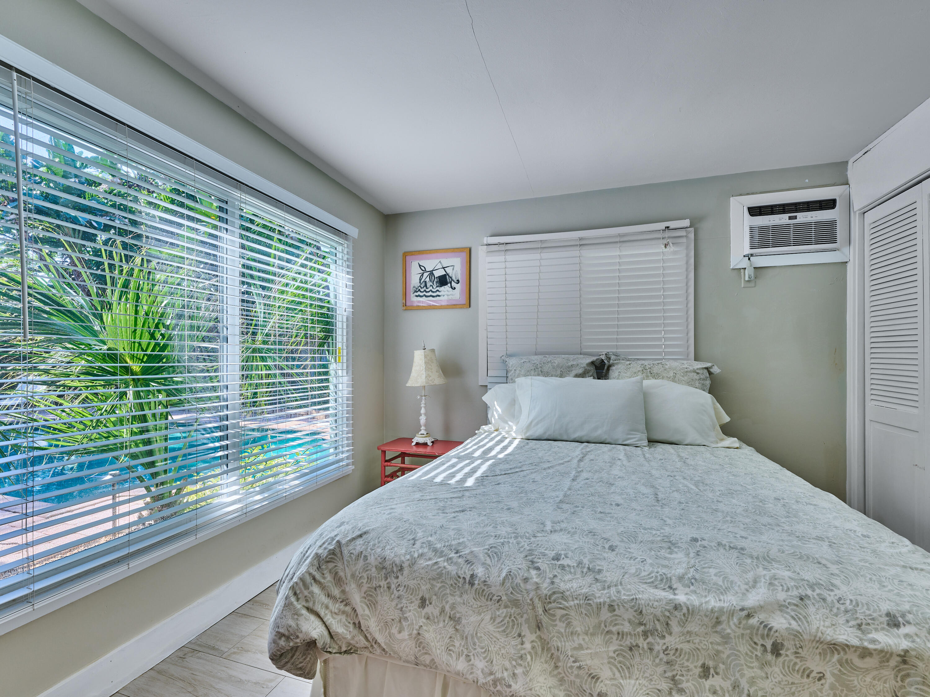 301 Northwest 3rd Court Boca Raton, FL 33432 - Photo 27 of 45 a bedroom with a large bed and a large window