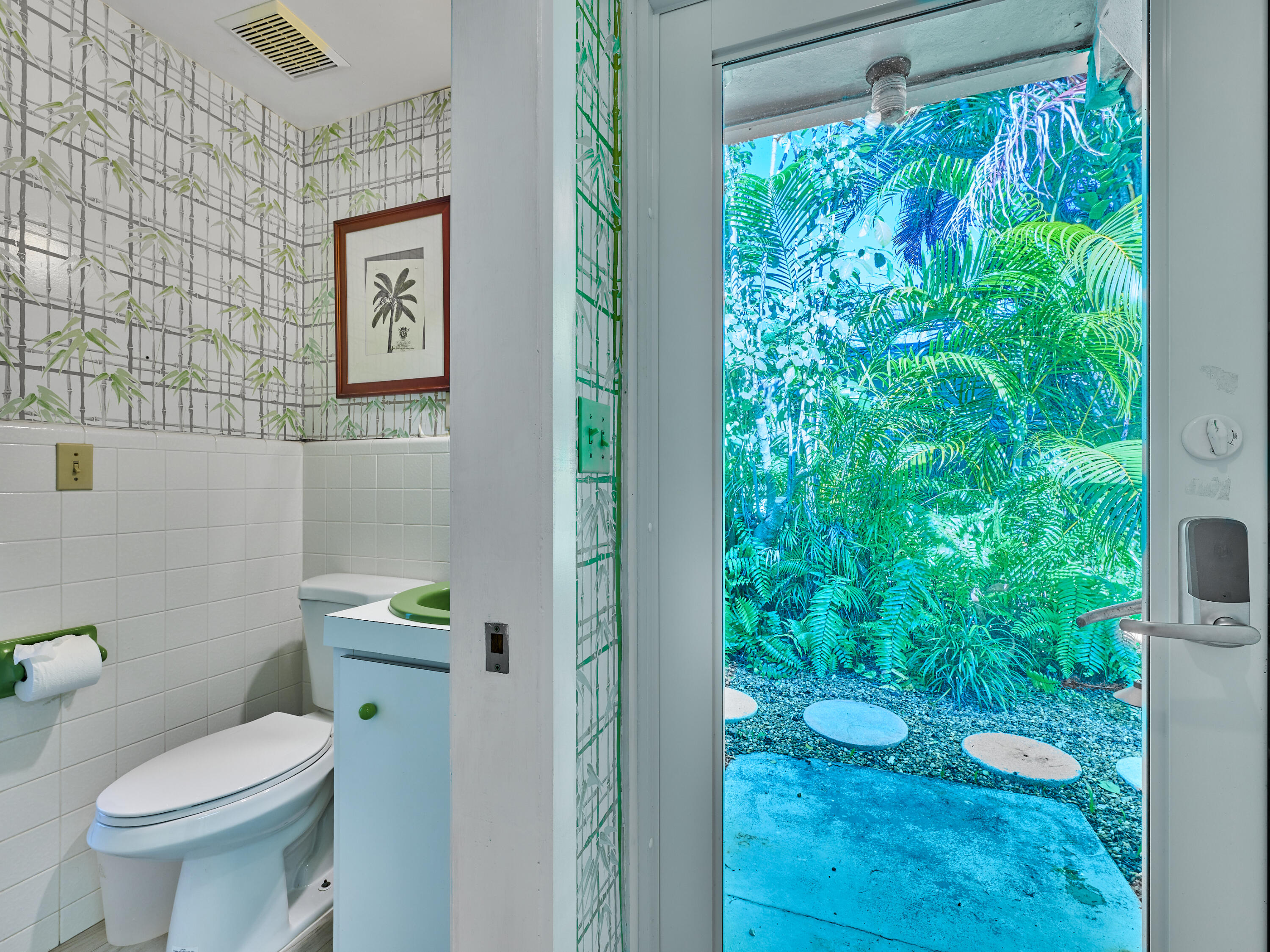 301 Northwest 3rd Court Boca Raton, FL 33432 - Photo 29 of 45 a white toilet sitting next to a shower curtain