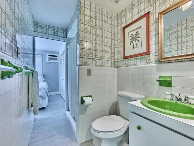 a bathroom with a sink a toilet and shower curtain