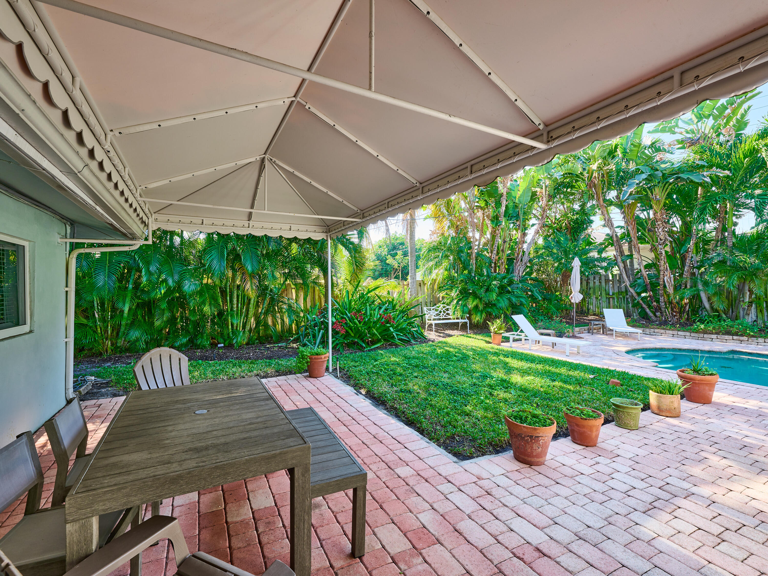 301 Northwest 3rd Court Boca Raton, FL 33432 - Photo 34 of 45 a view of a patio with a table chairs and a backyard