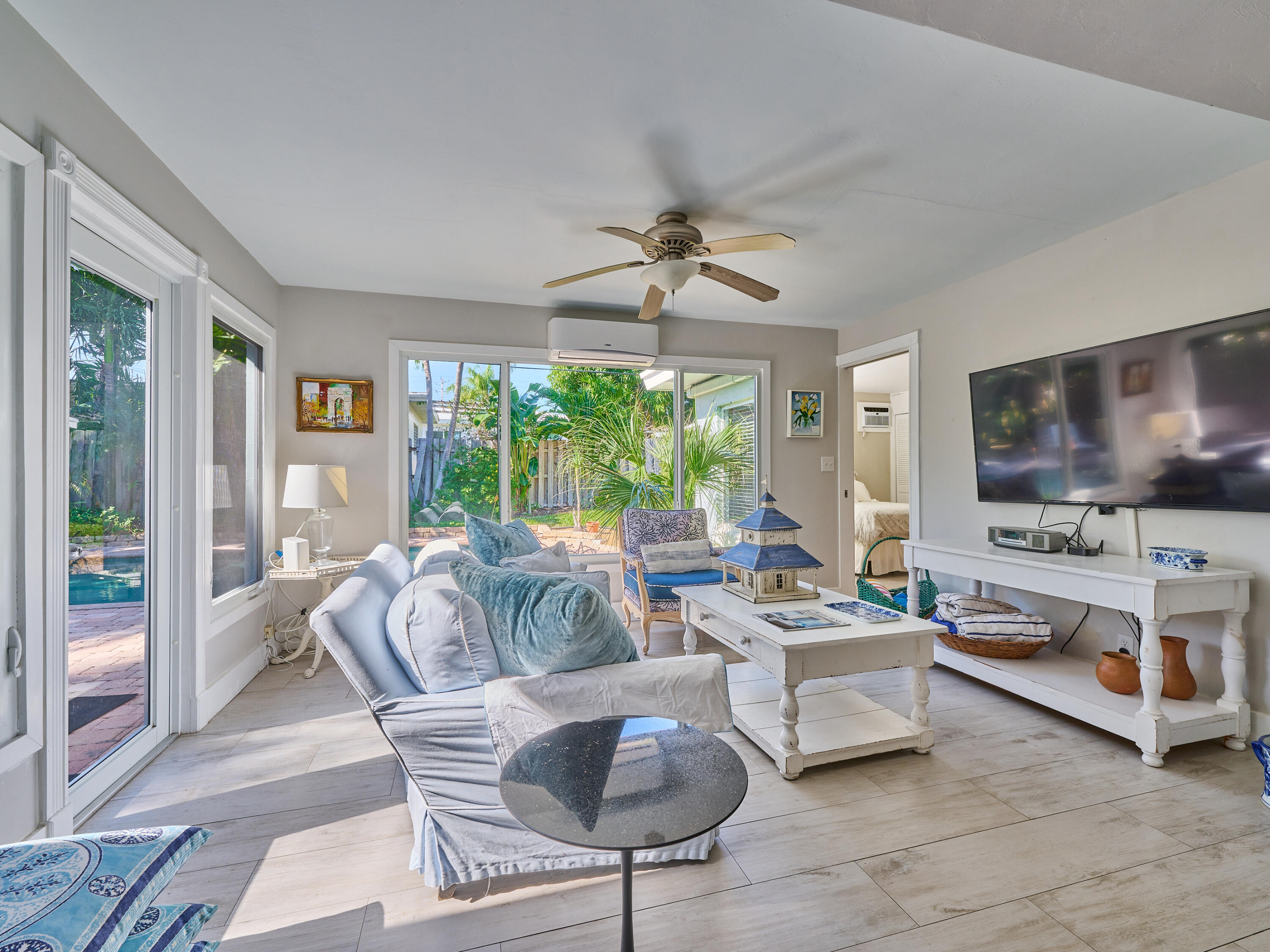 301 Northwest 3rd Court Boca Raton, FL 33432 - Photo 43 of 45 a living room with furniture and a flat screen tv