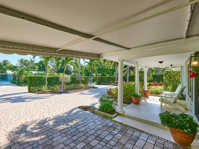 a view of a patio with chairs and floor to ceiling window