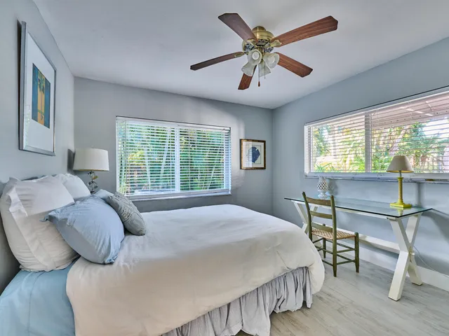 a bedroom with a bed and a table with chair