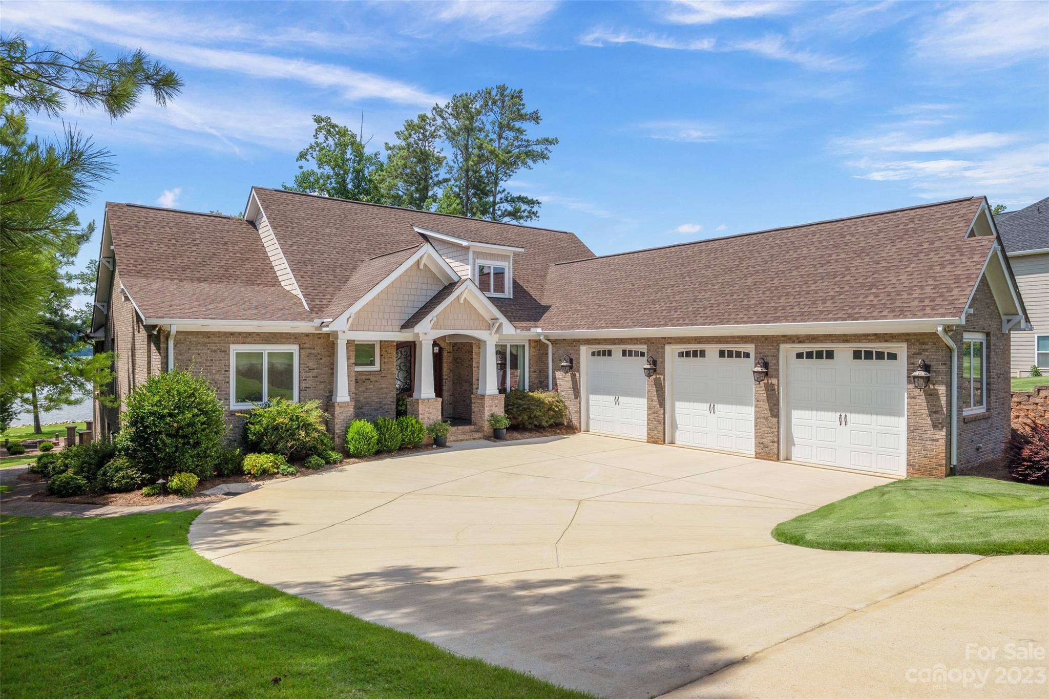 a front view of a house with a yard and potted plants