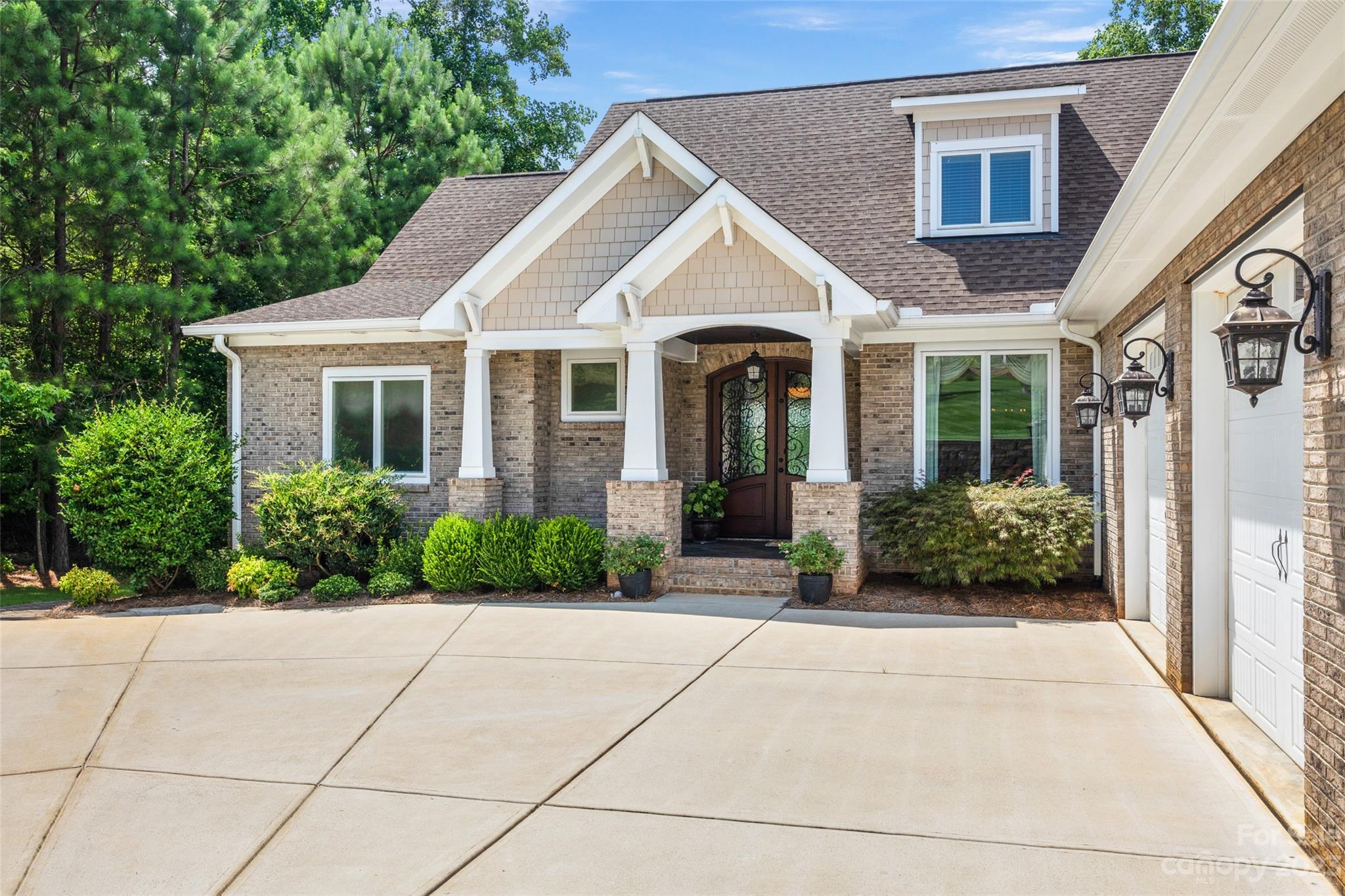 10285 Lakeshore Drive Lancaster, SC 29720 - Photo 11 of 48 a view of a white house with potted plants and a potted plant