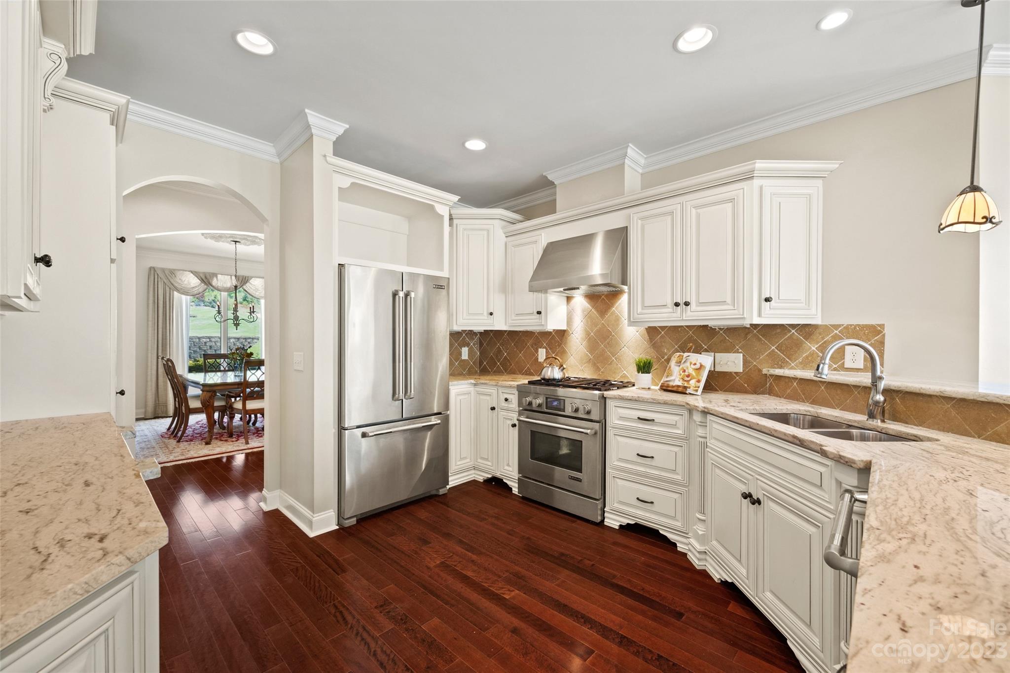 10285 Lakeshore Drive Lancaster, SC 29720 - Photo 20 of 48 a kitchen with a refrigerator stove and wooden floors