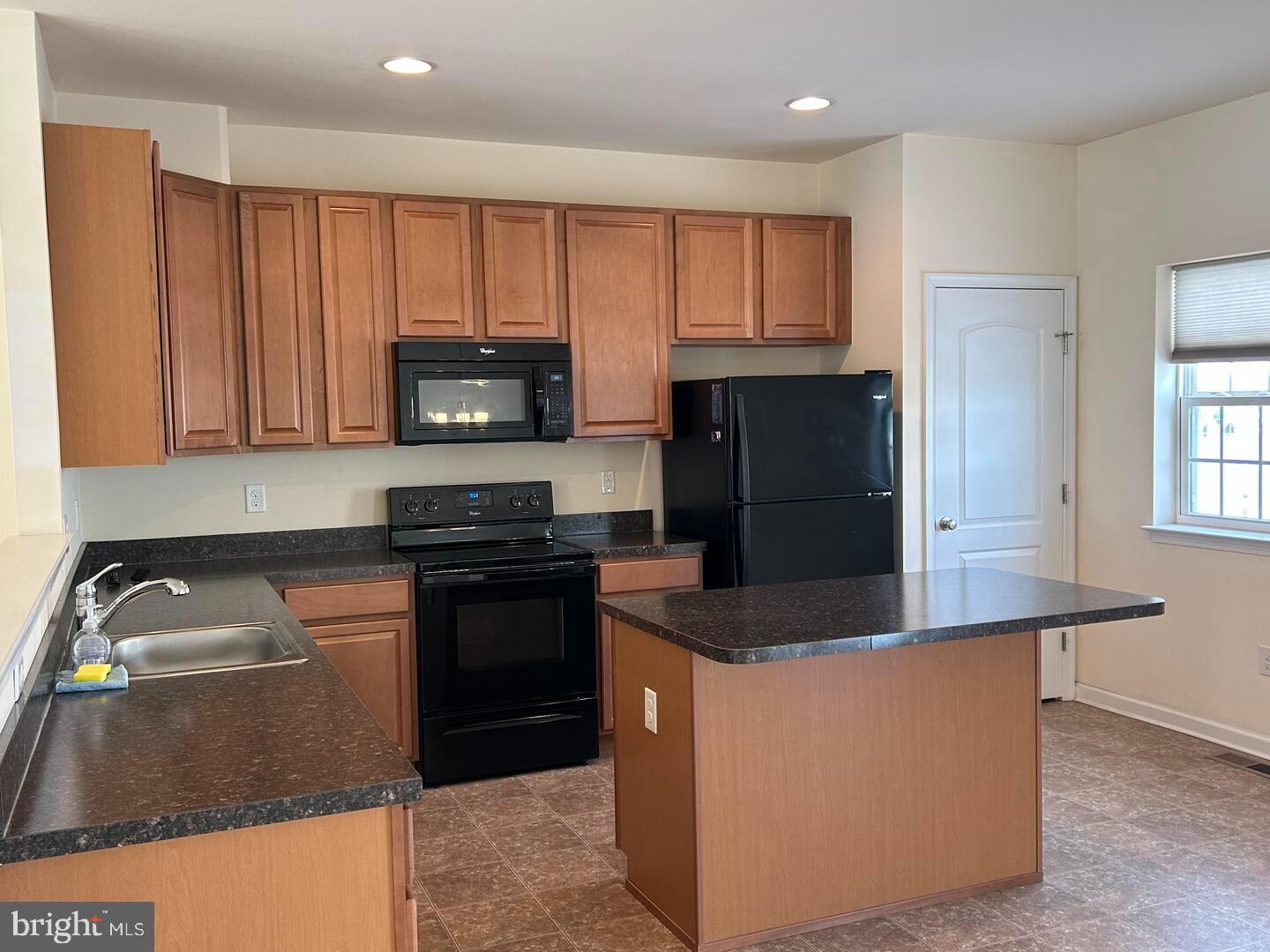 475 Toftrees Drive Middletown, DE 19709 - Photo 5 of 11 a kitchen with granite countertop a refrigerator and a stove top oven