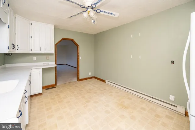 a kitchen with granite countertop white cabinets white stainless steel appliances with a sink and dishwasher
