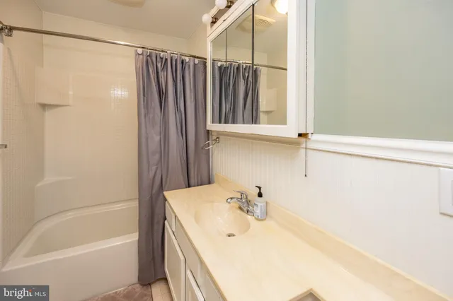 a utility room with cabinets washer and dryer