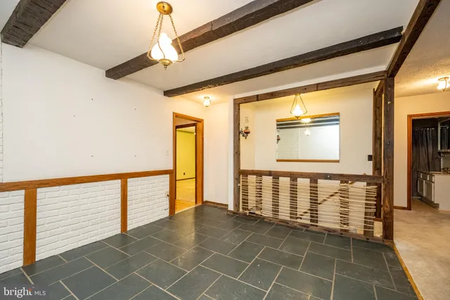 a view of a livingroom with a ceiling fan and window