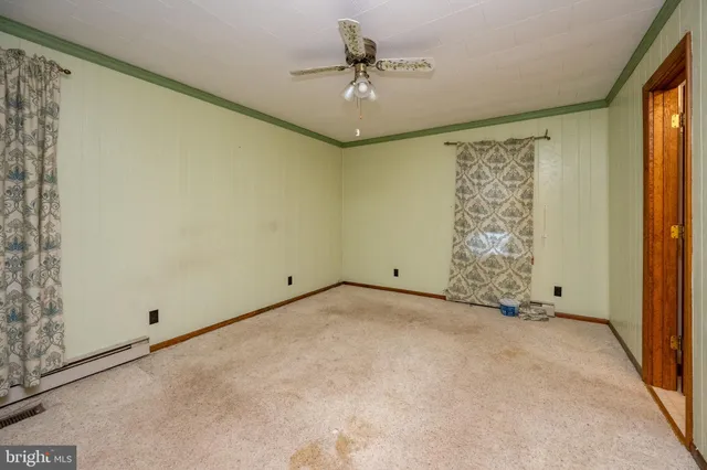 an empty room with windows and closet