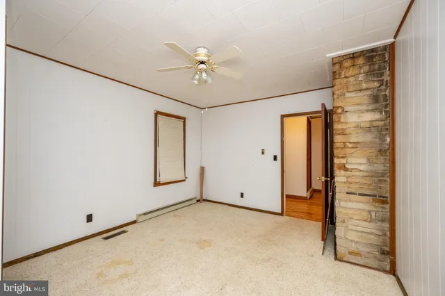 a view of a livingroom with wooden floor and a sink