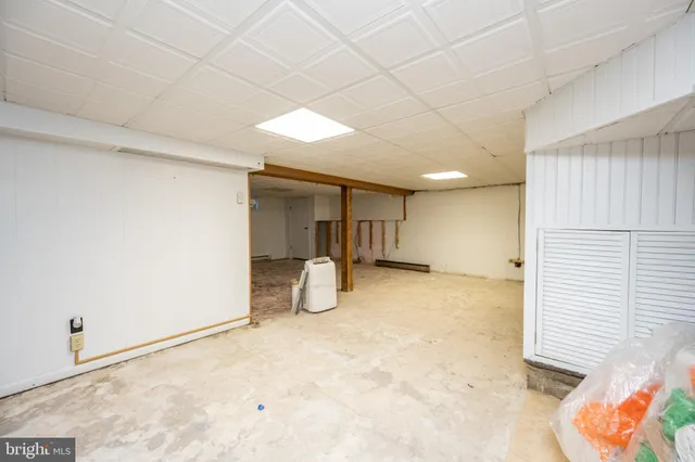 a view of a livingroom with wooden floor and furniture