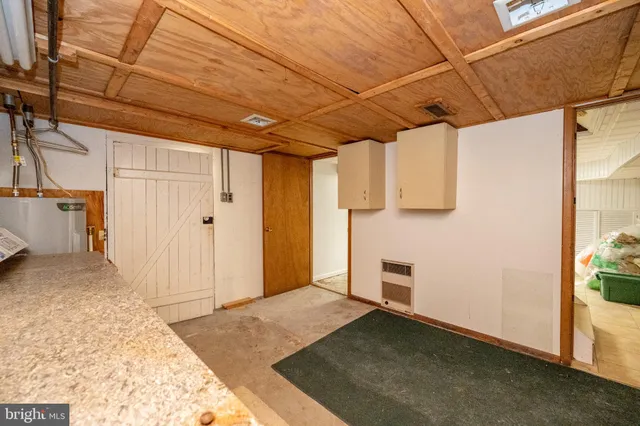 a view of a room with wooden walls and entryway