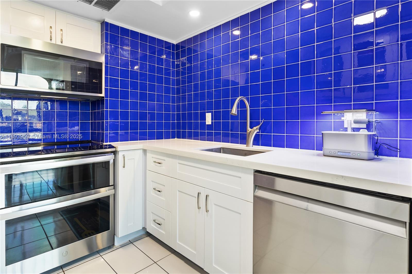 77 Crandon Boulevard, Unit 3C Key Biscayne, FL 33149 - Photo 14 of 34 a kitchen with a stove microwave and sink