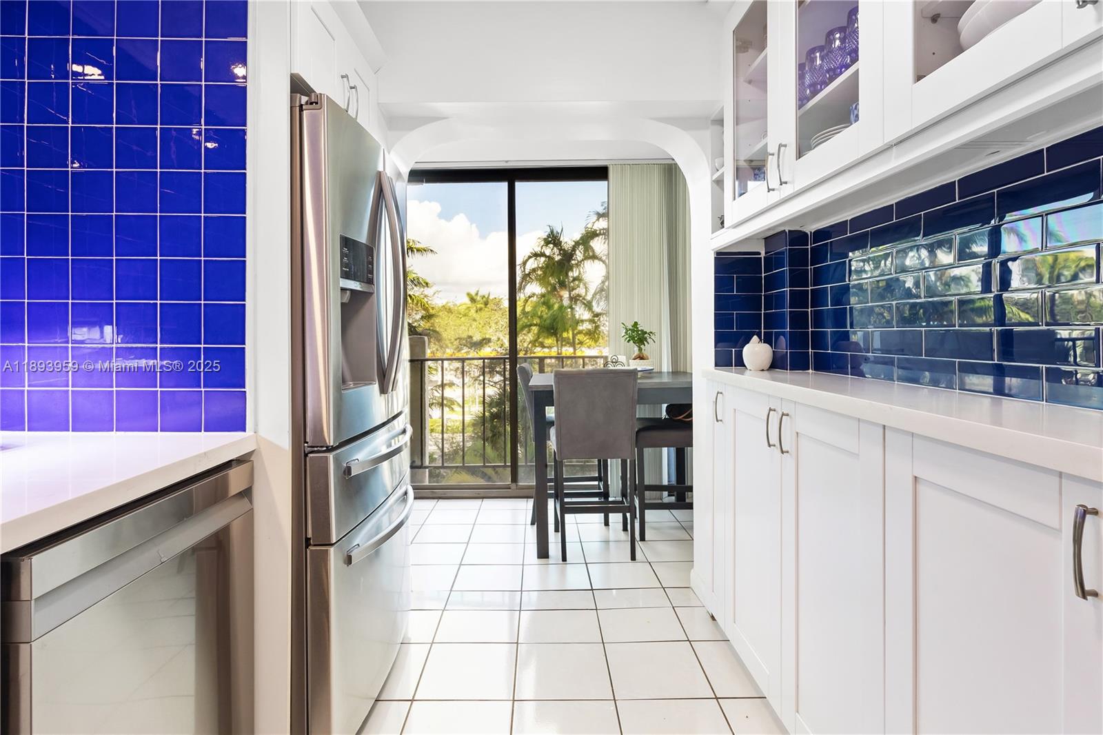 77 Crandon Boulevard, Unit 3C Key Biscayne, FL 33149 - Photo 16 of 34 a kitchen with stainless steel appliances kitchen island granite countertop a refrigerator and a sink