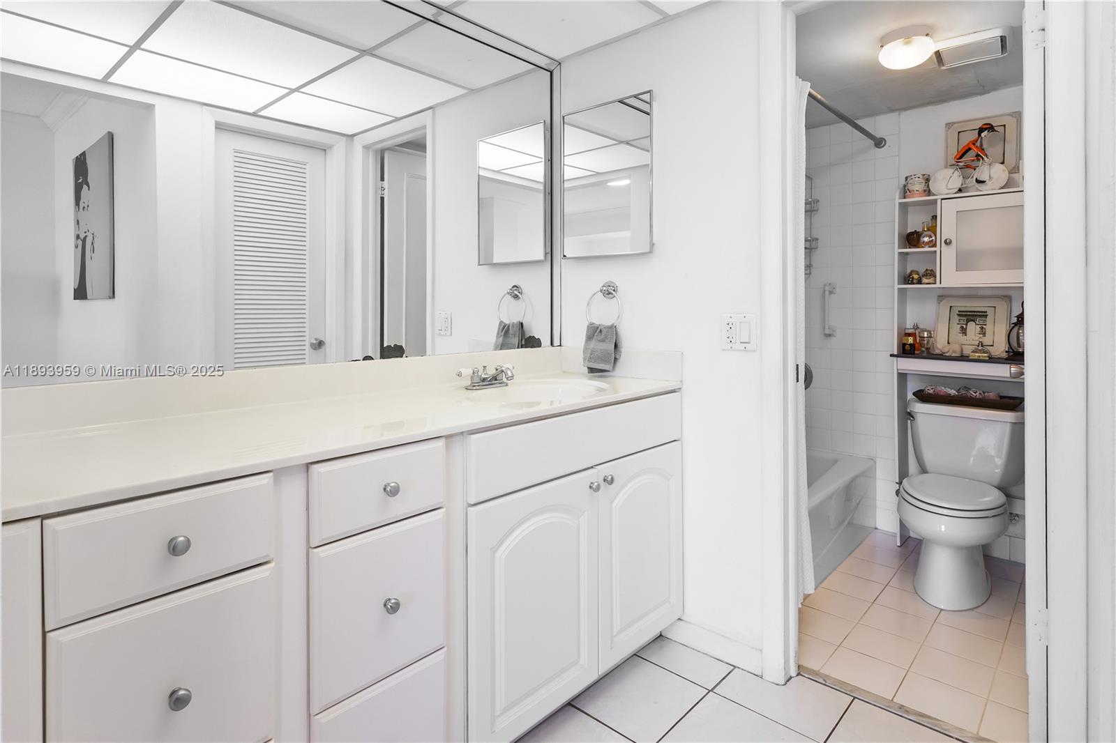 77 Crandon Boulevard, Unit 3C Key Biscayne, FL 33149 - Photo 19 of 34 a bathroom with a double vanity sink toilet and a mirror