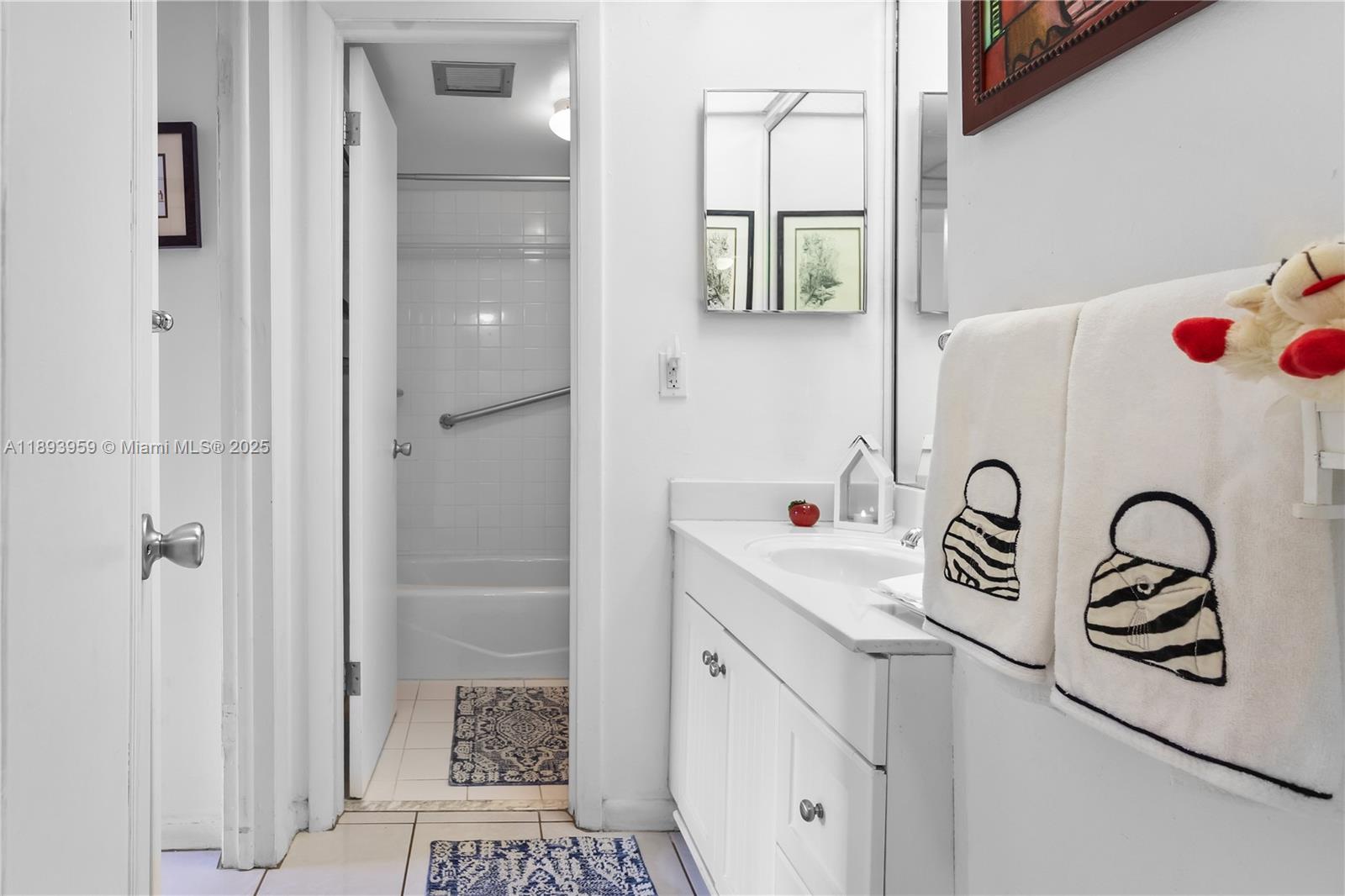 77 Crandon Boulevard, Unit 3C Key Biscayne, FL 33149 - Photo 24 of 34 a bathroom with a sink a toilet and shower