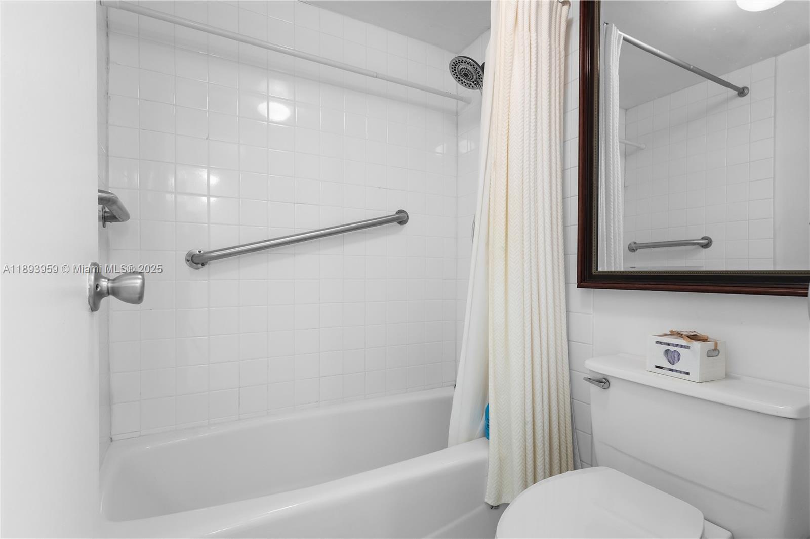 77 Crandon Boulevard, Unit 3C Key Biscayne, FL 33149 - Photo 25 of 34 a bathroom with a granite countertop bathtub shower sink vanity and toilet