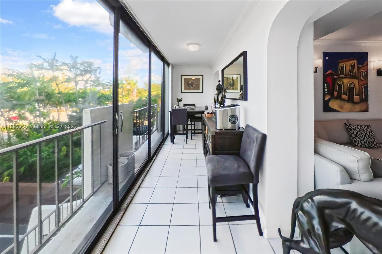 77 Crandon Boulevard, Unit 3C Key Biscayne, FL 33149 - Photo 27 of 34 a living room with furniture and a large window