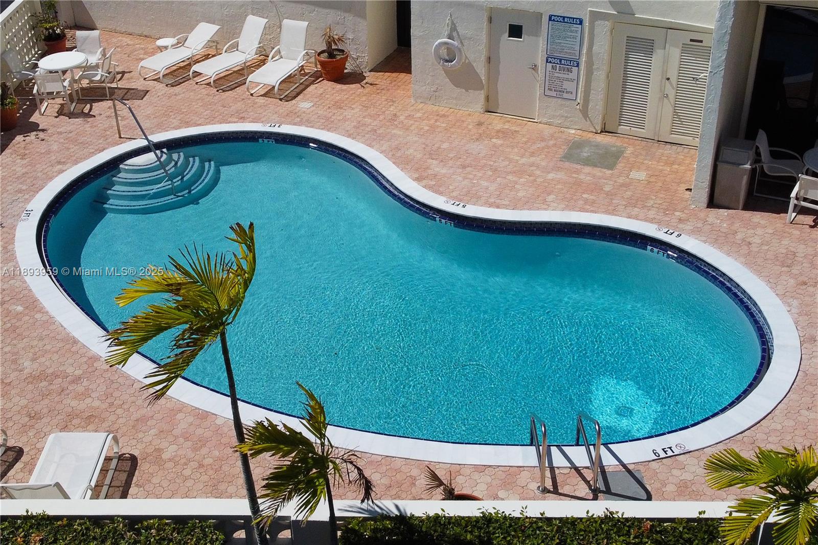 77 Crandon Boulevard, Unit 3C Key Biscayne, FL 33149 - Photo 32 of 34 a view of a swimming pool with a yard