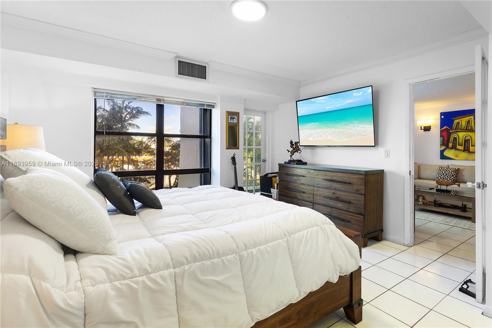 77 Crandon Boulevard, Unit 3C Key Biscayne, FL 33149 - Photo 4 of 34 a bedroom with a bed and dresser