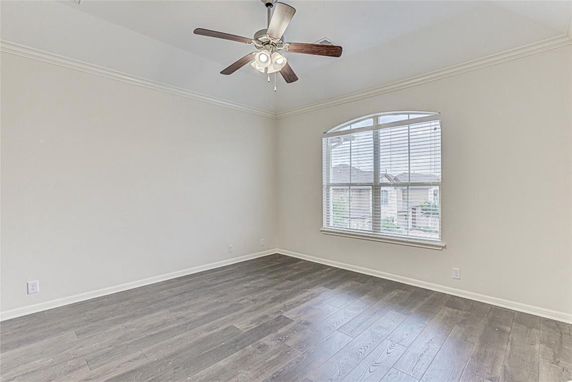 14001 Avery Ranch Boulevard, Unit 103 Austin, TX 78717 - Photo 14 of 29 an empty room with wooden floor ceiling fan and windows