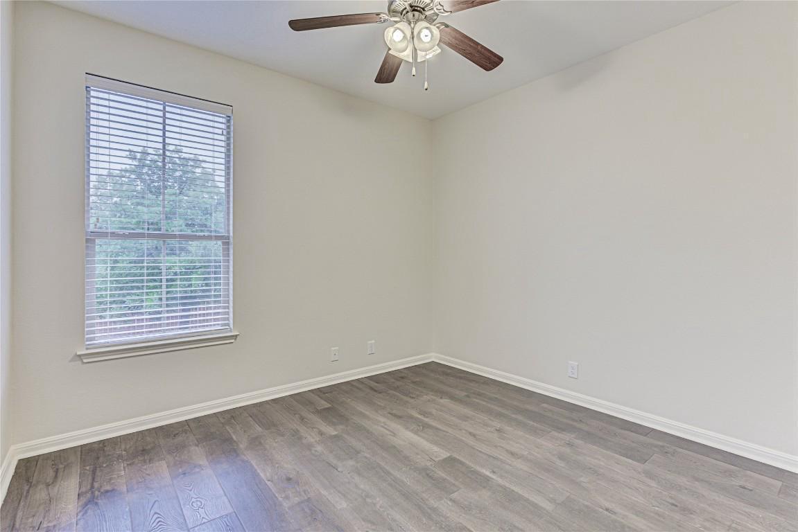 14001 Avery Ranch Boulevard, Unit 103 Austin, TX 78717 - Photo 21 of 29 wooden floor in an empty room with a window