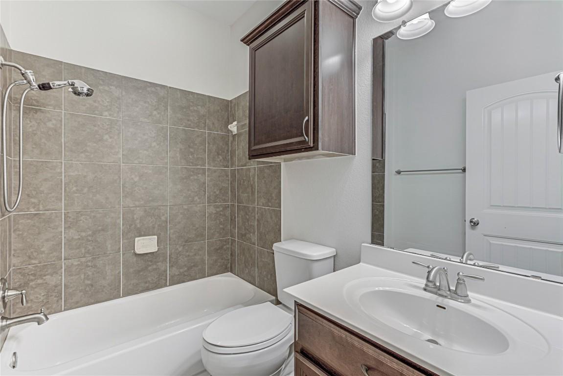 14001 Avery Ranch Boulevard, Unit 103 Austin, TX 78717 - Photo 23 of 29 a bathroom with a sink a toilet and shower