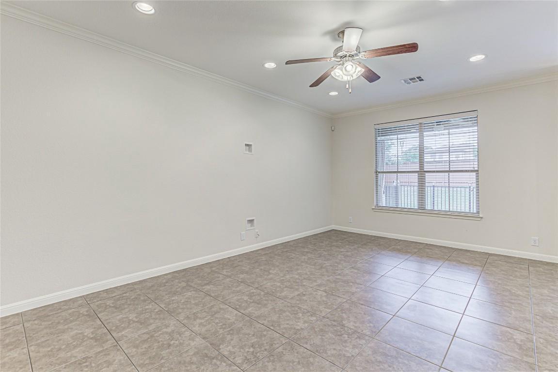 14001 Avery Ranch Boulevard, Unit 103 Austin, TX 78717 - Photo 4 of 29 an empty room with windows and chandelier fan