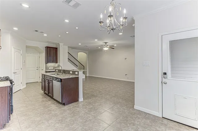 a large kitchen with a sink and stainless steel appliances