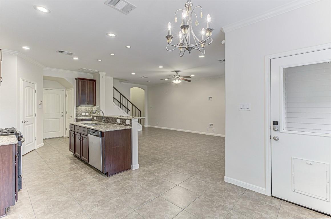 14001 Avery Ranch Boulevard, Unit 103 Austin, TX 78717 - Photo 6 of 29 a large kitchen with a sink and stainless steel appliances