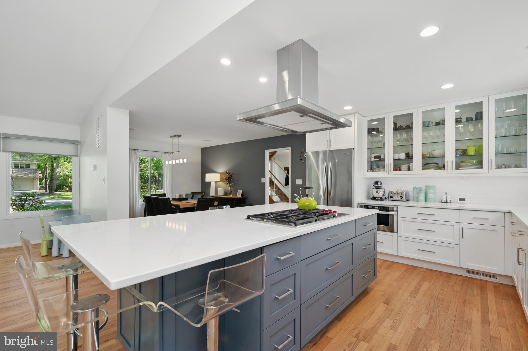 8024 Fenway Road Bethesda, MD 20817 - Photo 20 of 64 a kitchen with a stove a refrigerator and a dining table with wooden floor