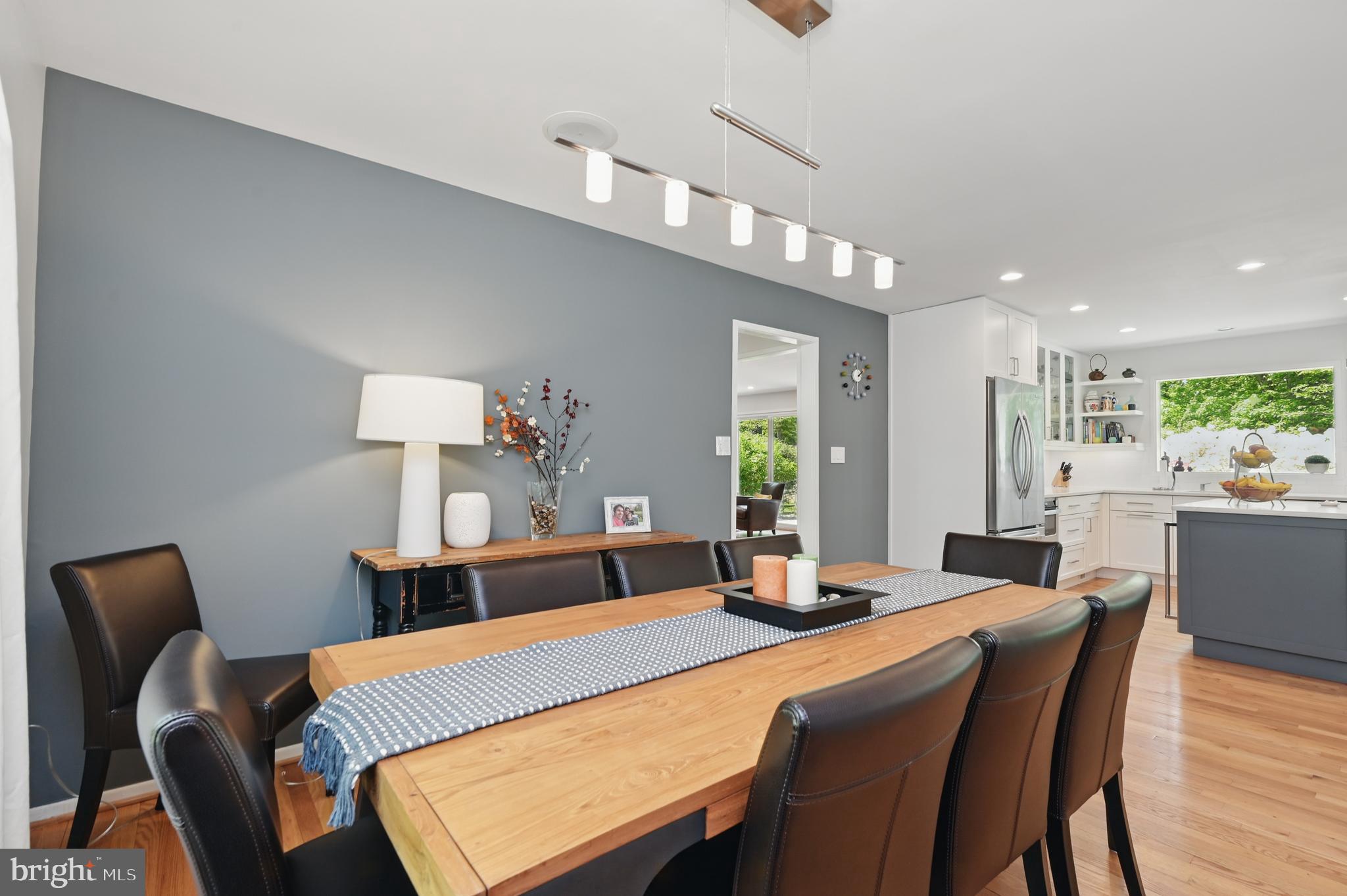 8024 Fenway Road Bethesda, MD 20817 - Photo 24 of 64 a dining room with a table chairs and a kitchen view