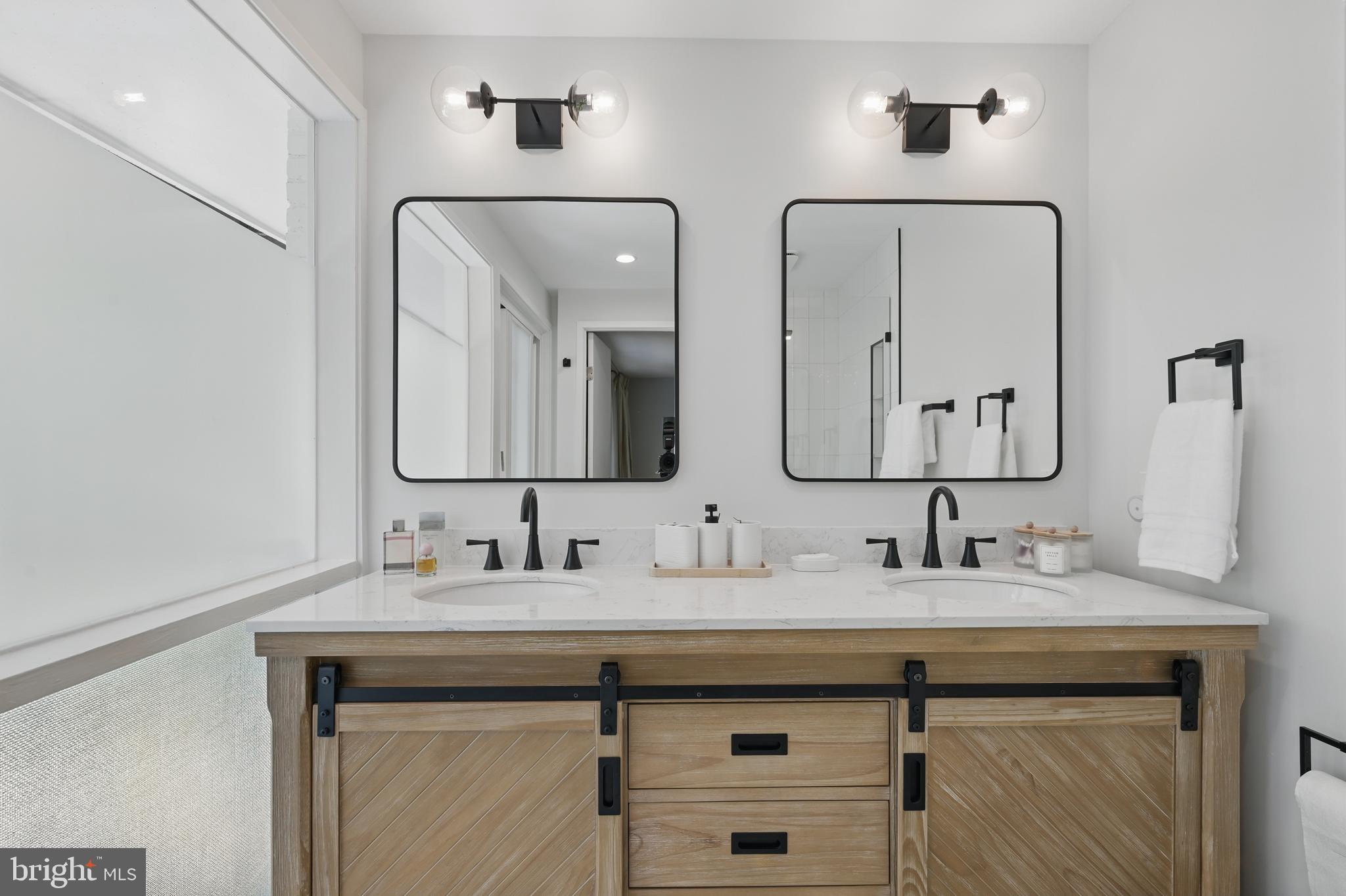 8024 Fenway Road Bethesda, MD 20817 - Photo 43 of 64 a bathroom with a double vanity sink and mirror