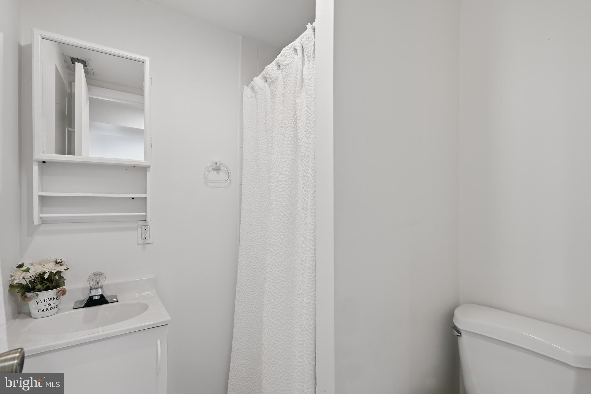8024 Fenway Road Bethesda, MD 20817 - Photo 53 of 64 a bathroom with a sink toilet and vanity