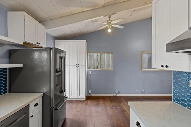 a kitchen with stainless steel appliances granite countertop a refrigerator a sink and dishwasher