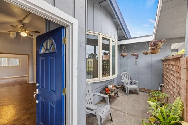 a view of living room kitchen and entryway