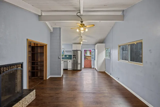 a view of an empty room with window and cabinet