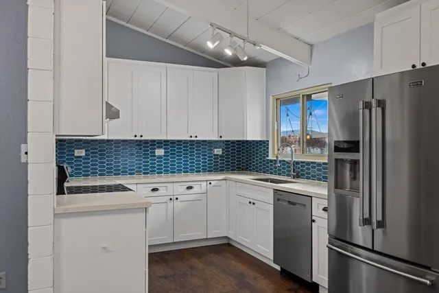 a kitchen with a sink stove and refrigerator