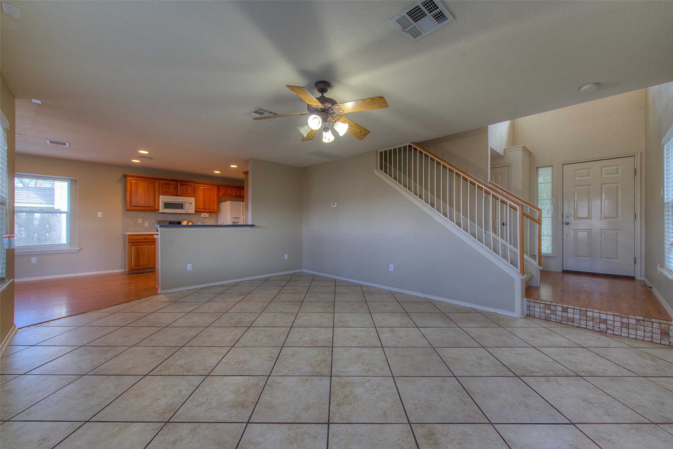 1148 Sundrop Place Round Rock, TX 78665 - Photo 6 of 19 a view of an empty room and kitchen view with wooden floor