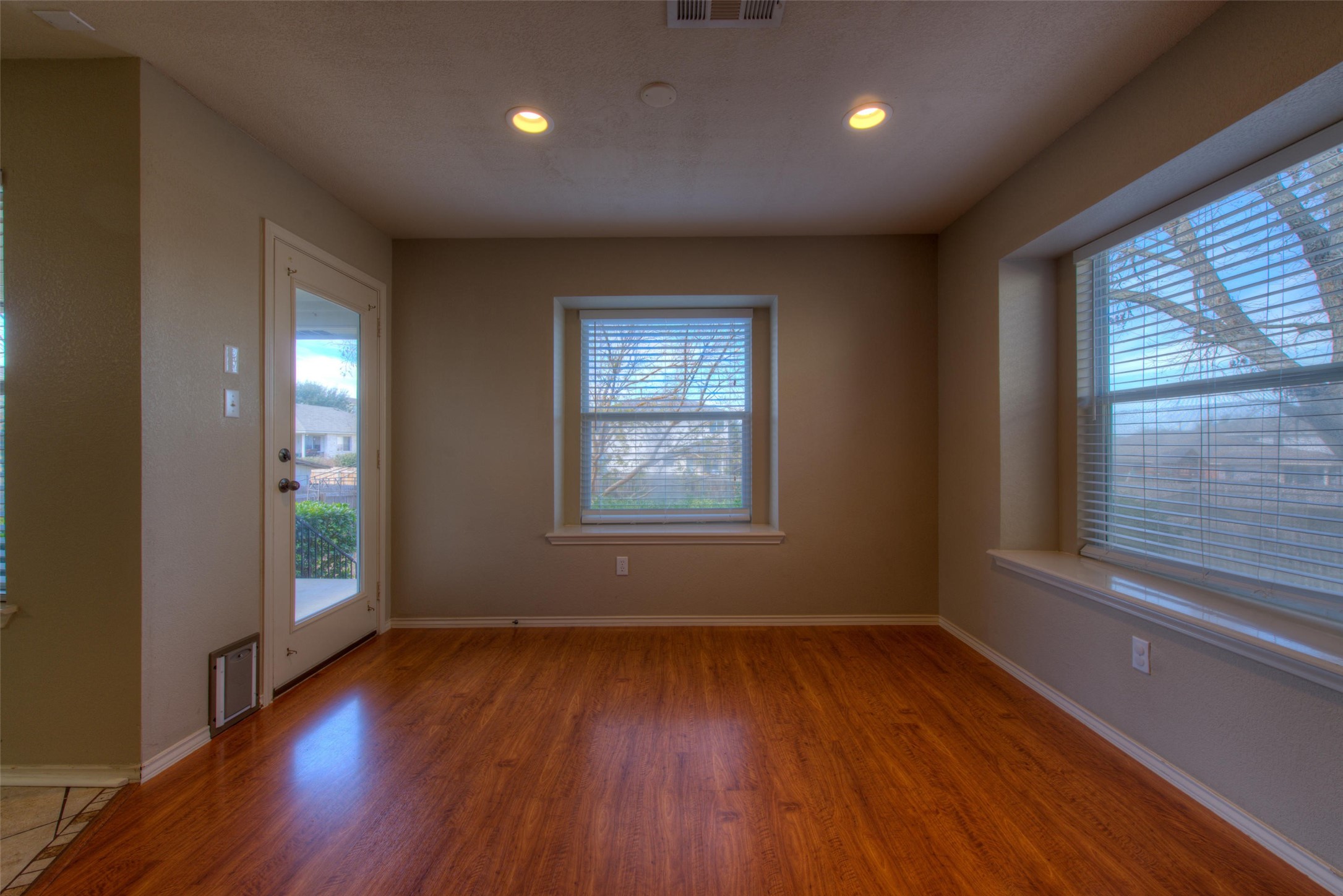 1148 Sundrop Place Round Rock, TX 78665 - Photo 7 of 19 an empty room with wooden floor and windows