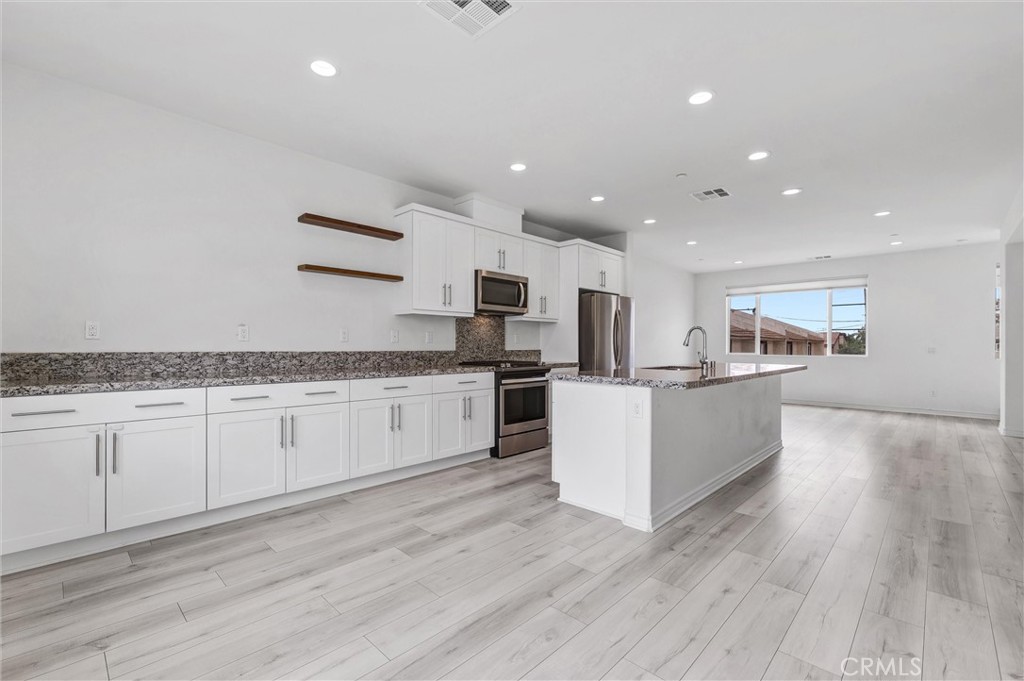 1245 Oliva Court Duarte, CA 91010 - Photo 13 of 23 a large kitchen with stainless steel appliances granite countertop a large counter top and a stove with wooden floor