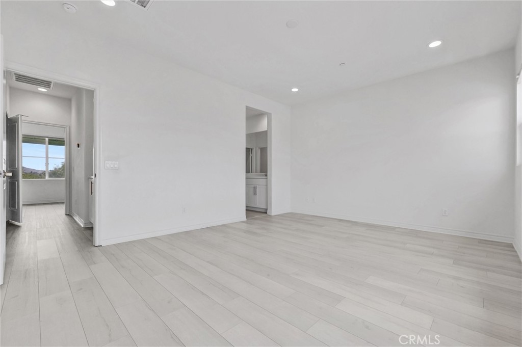 1245 Oliva Court Duarte, CA 91010 - Photo 15 of 23 a view of an empty room with wooden floor and a bathroom