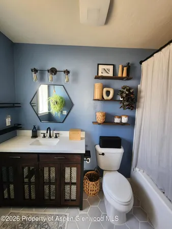 a bathroom with a toilet a sink and a mirror