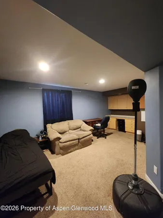 a room with two bed and a chair