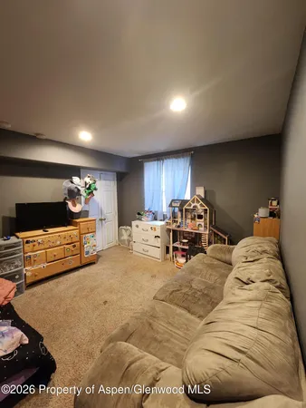 a bed room with furniture and a chandelier