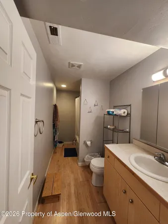 a spacious bathroom with a shower sink and mirror