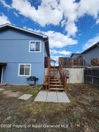 a view of a backyard with sitting area