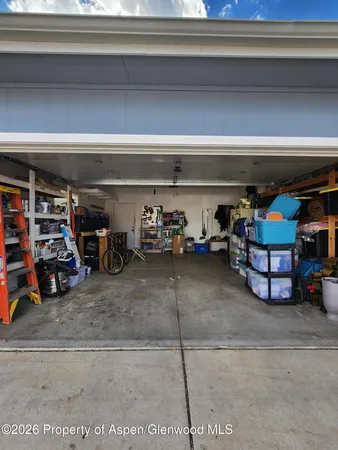 a view of parking garage with cars